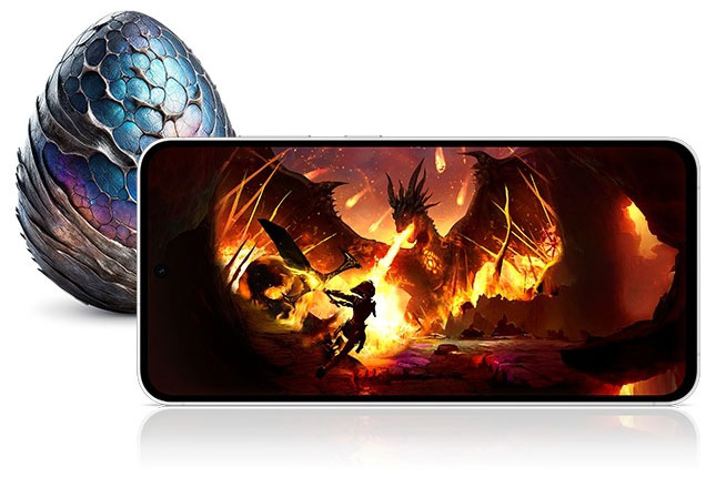 A Galaxy S24 FE device seen from the front and horizontal, displaying a vivid image of a warrior battling a dragon in a fiery setting. Behind the device, there is a dragon-like egg with blue and purple scales.