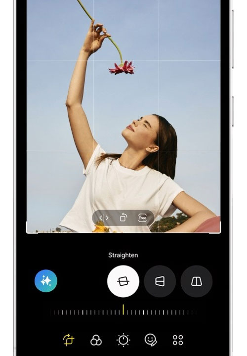 A woman holds a flower above her head. After clicking the Generate button, the tool resizes the flower and fills in the background, creating a final photo with the larger flower.